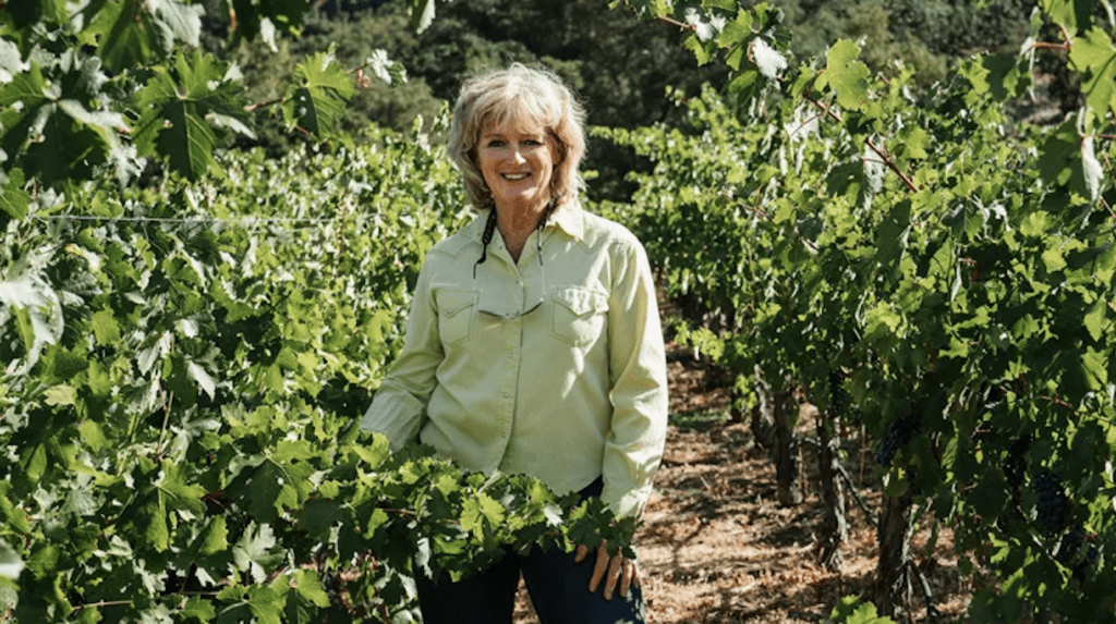 American female Winemaker Heidi Barrett walking in the vineyard.